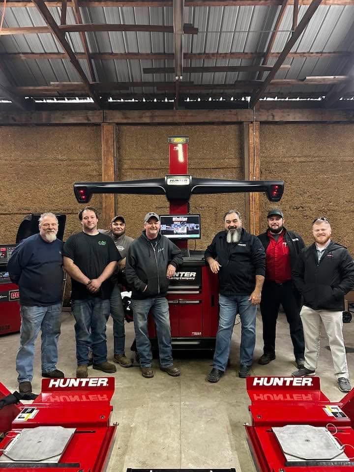 People gathered around the Hunter alignment equipment at J-Byrd’s shop