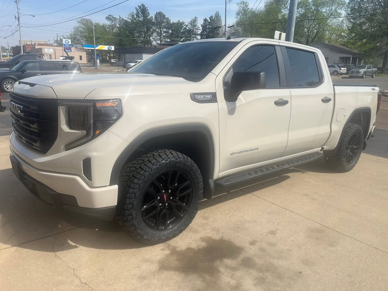 White pickup with black wheels outside J-Byrd Automotive